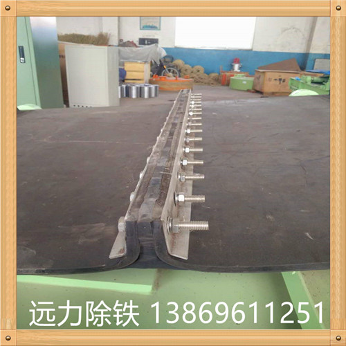 橡膠除鐵器皮帶 除鐵器環(huán)形帶接頭方法有三種：   　　(1)直接硫化成環(huán)形帶子.  　　(2)硫化時(shí)留生頭 除鐵器環(huán)形帶生產(chǎn)商,使用時(shí)根據要求現場(chǎng)加熱加壓使接頭部分硫化.  　　(3)用膠黏劑現場(chǎng)黏合.由于無(wú)機械接頭,運行平穩,適用于選礦,化肥等部門(mén)的物料輸送.  　　除鐵器環(huán)形輸送帶是指平型輸送帶生產(chǎn)完成后,因為使用的環(huán)境或者條件限制,必須使用環(huán)形輸送帶時(shí),我們會(huì )對平型輸送帶進(jìn)行硫化接頭(又稱(chēng)熱粘),使其變?yōu)榄h(huán)形輸送帶.其帶芯接頭處強力可達到膠帶本體強力的90%,膠帶表面無(wú)明顯接頭缺陷.     因此 除鐵器環(huán)形帶的求購,環(huán)形輸送帶運輸平衡,使用伸長(cháng)小.環(huán)形輸送帶帶芯用優(yōu)質(zhì)全棉或維棉交織帆布制成,一般2-8層或用尼龍帆布(或聚酯帆布)作強力層.
